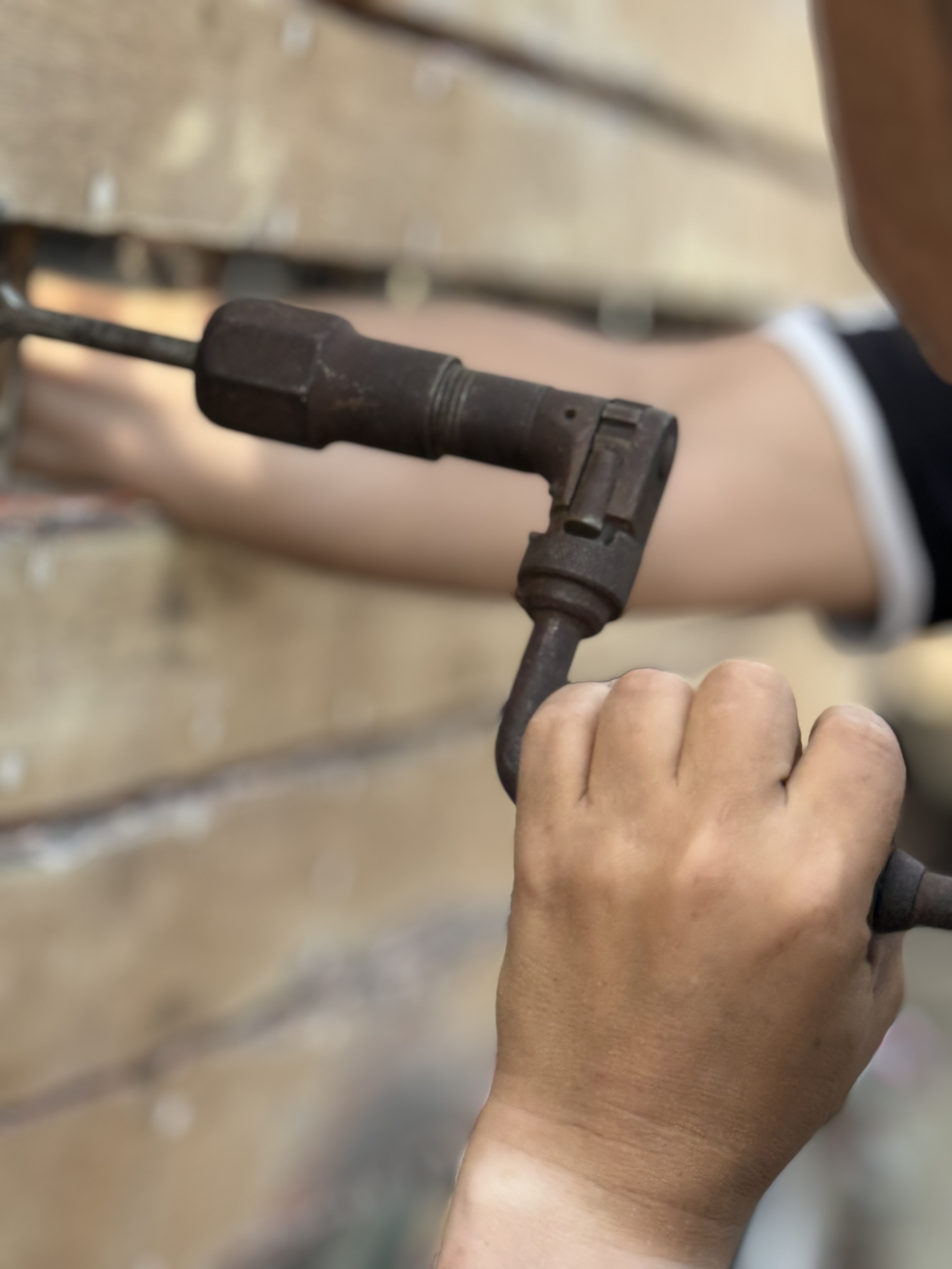 Shipwright replacing a plank on a historic wooden hull.