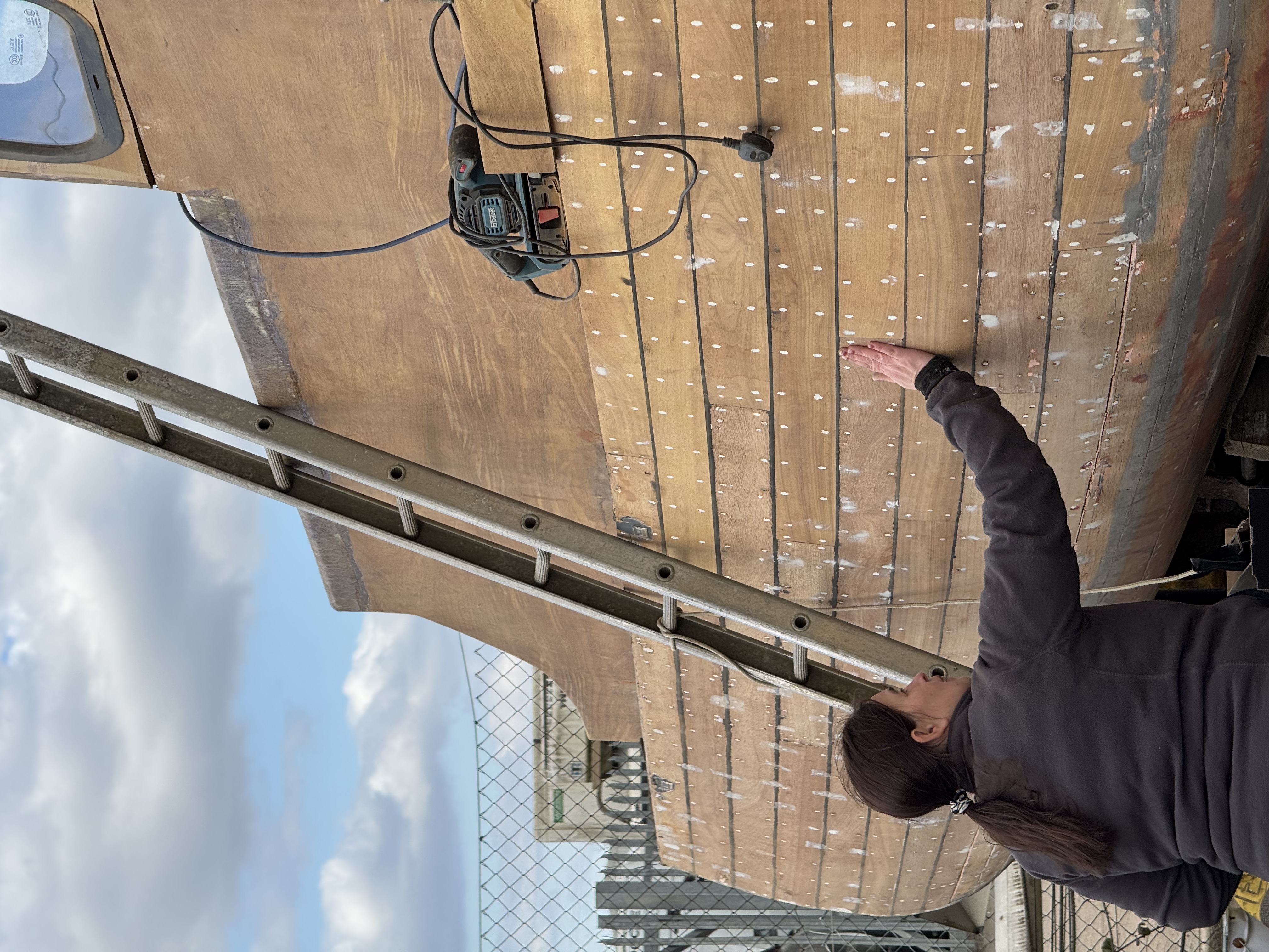 Replacing a plank on a traditional wooden boat hull.